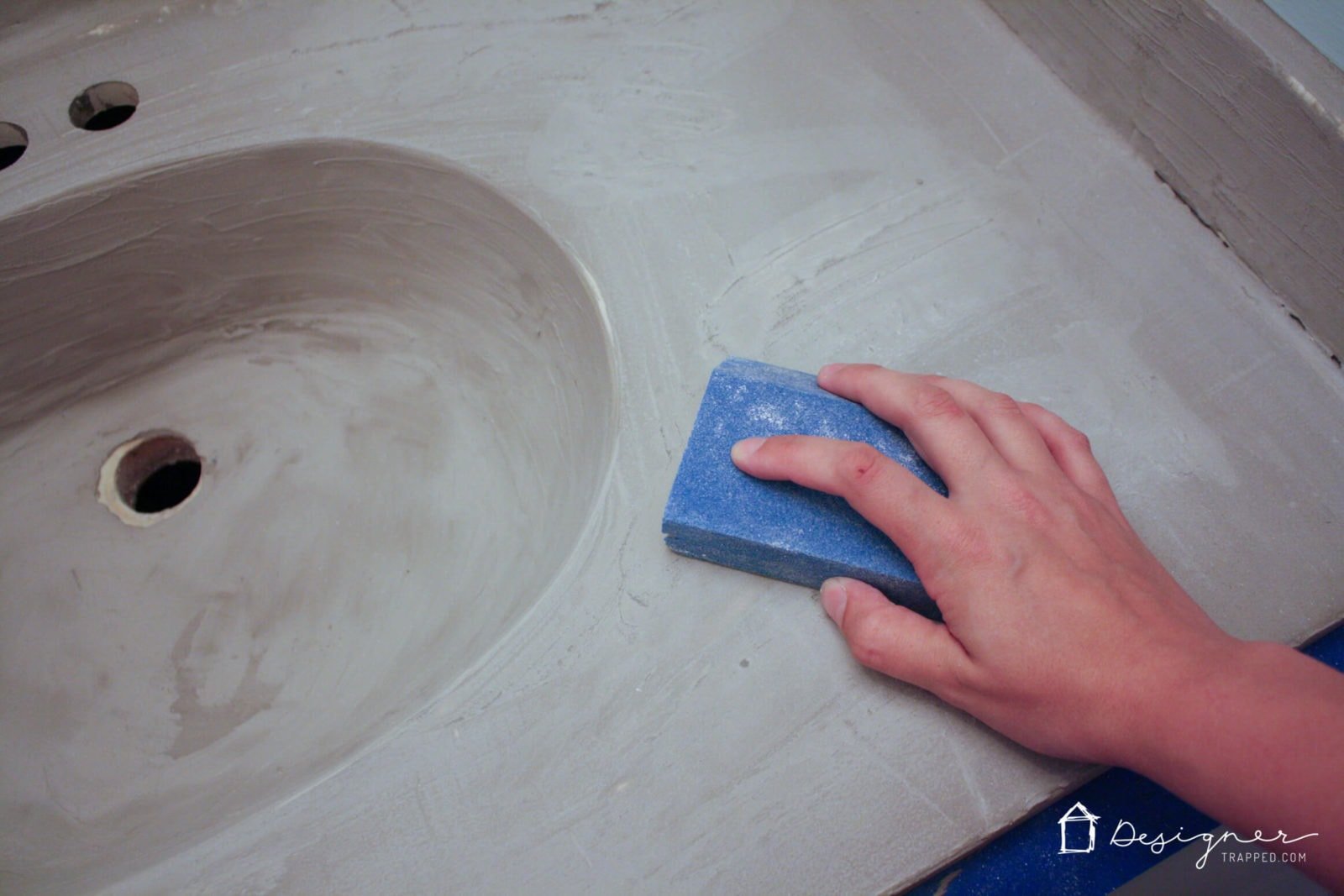 You can update your bathroom vanity without spending a fortune! This DIY vanity update using a concrete overlay with Ardex Feather Finish can be done for around $50 (including a new faucet). Check out the full tutorial!