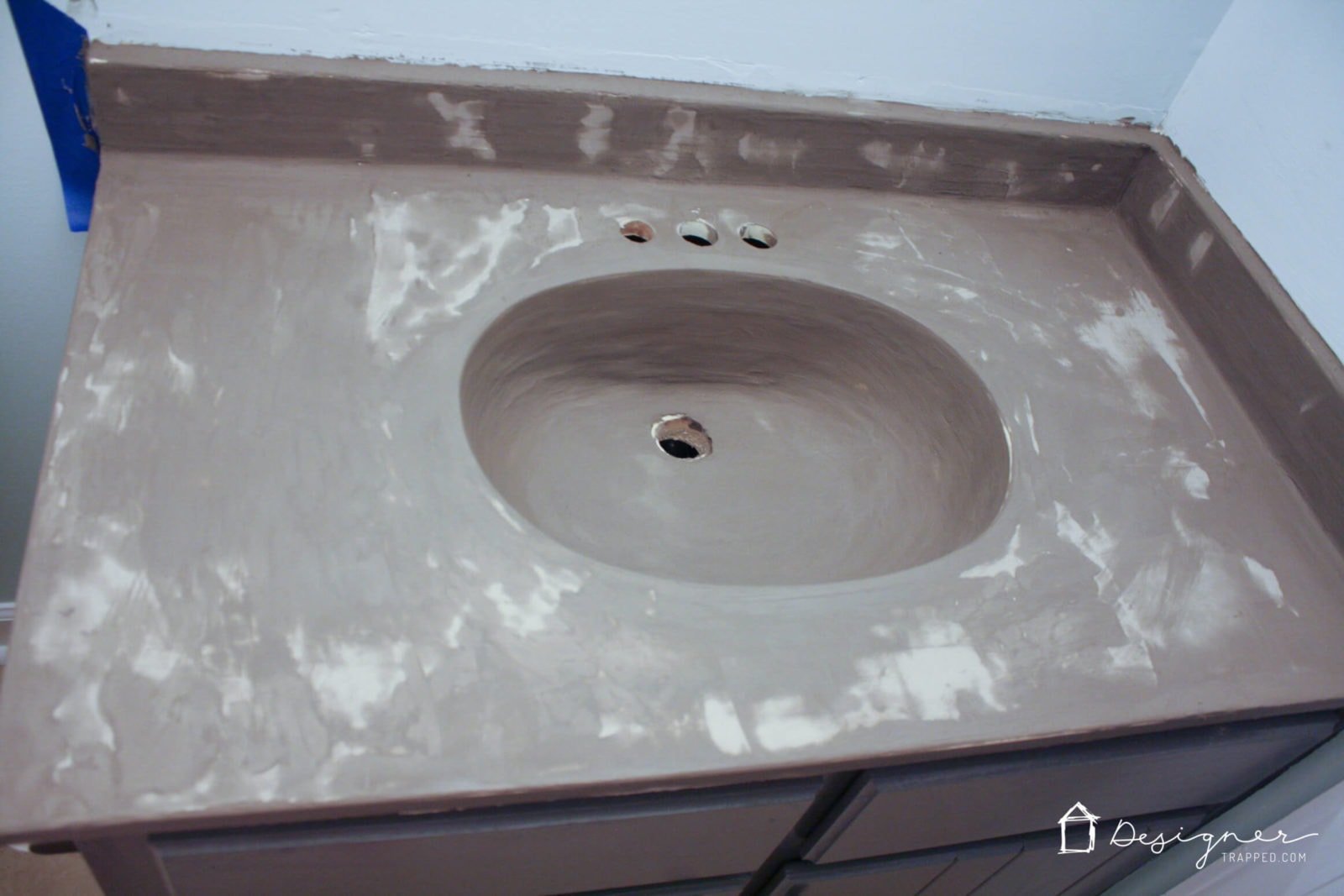 You can update your bathroom vanity without spending a fortune! This DIY vanity update using a concrete overlay with Ardex Feather Finish can be done for around $50 (including a new faucet). Check out the full tutorial!