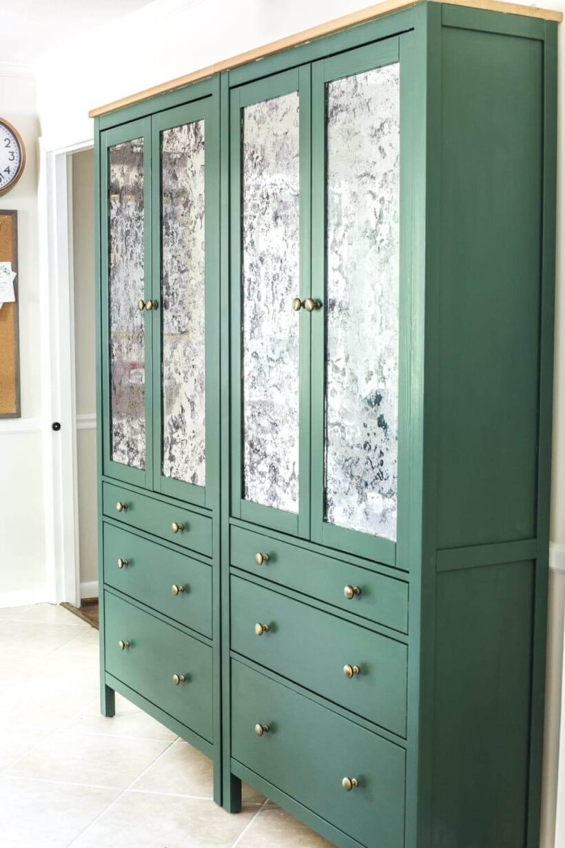 Two green Hemnes free-standing cabinets with drawers and doors have been turned into a free-standing pantry using these DIY IKEA hacks. 