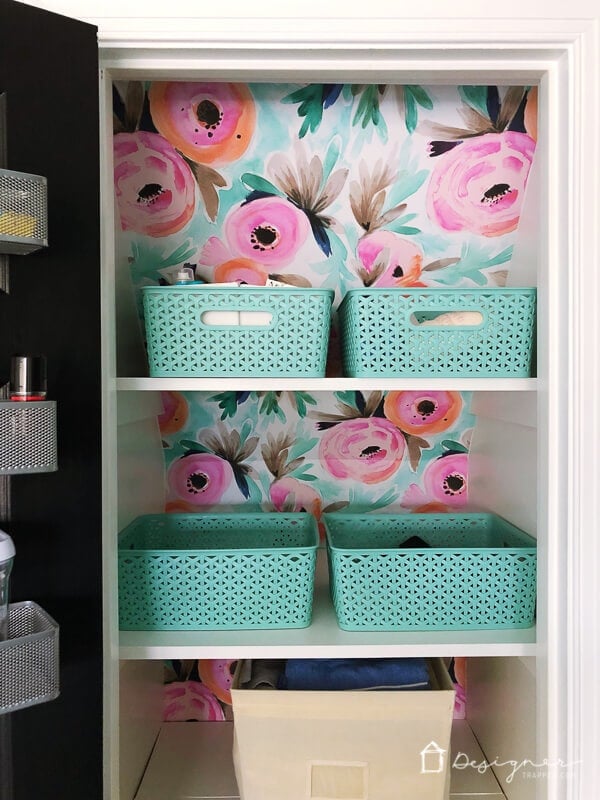 photo of colorful linen closet organization using bins to store similar items