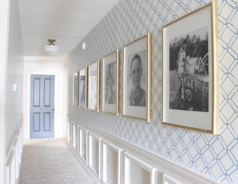 hallway with wallpaper and decorative molding