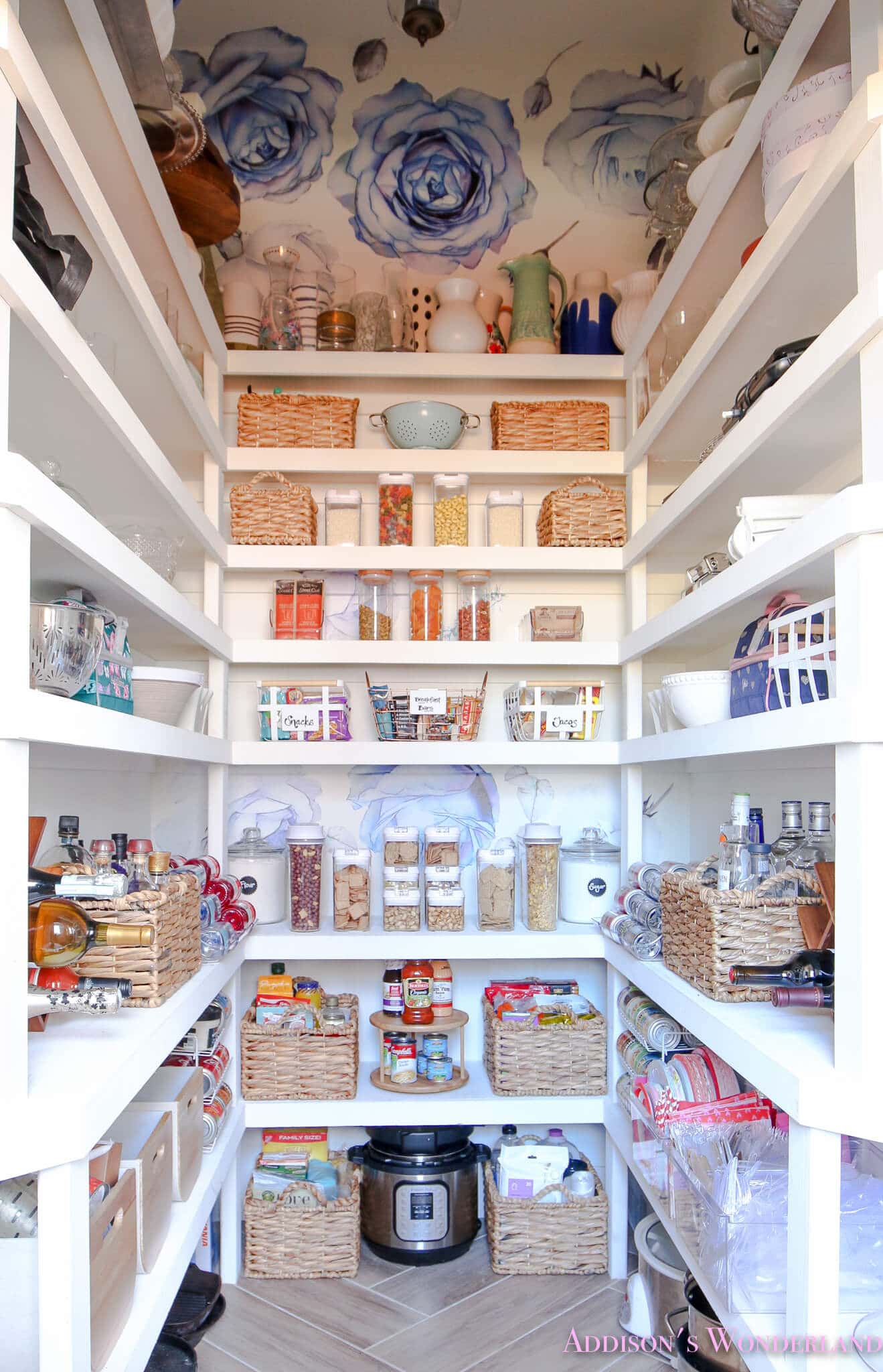 organized pantry with wallpapered ceiling