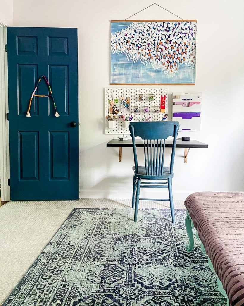 area rug over carpet in girl's bedroom