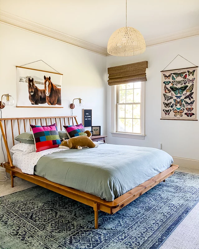 8' x 10' area rug under queen bed and over carpet in girl's bedroom