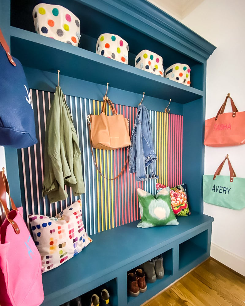 colorful mudroom with wood slat wall