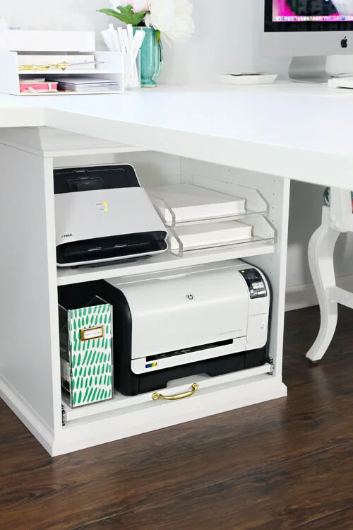 A Stuva printer cabinet under the corner of a white desk is an IKEA desk hack that provides ample storage. 