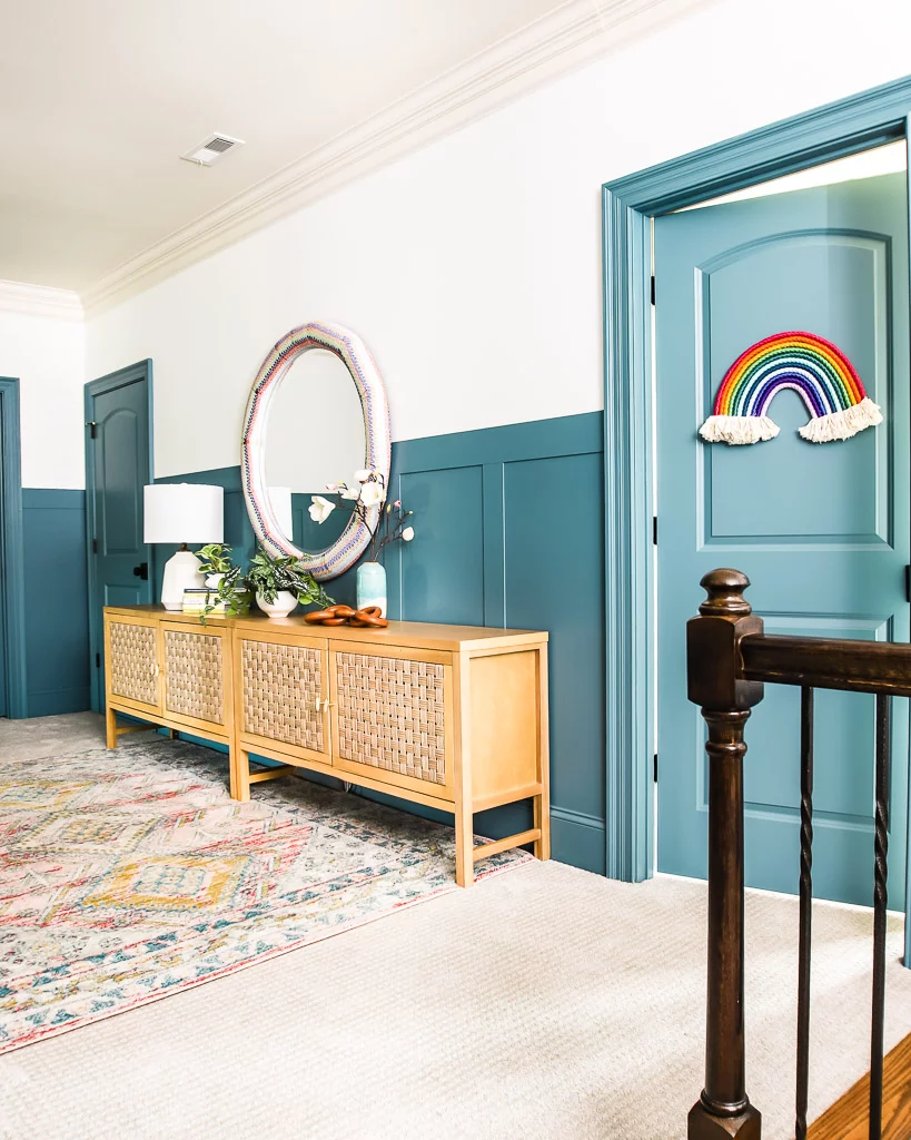 hallway with blue board and batten and console tables