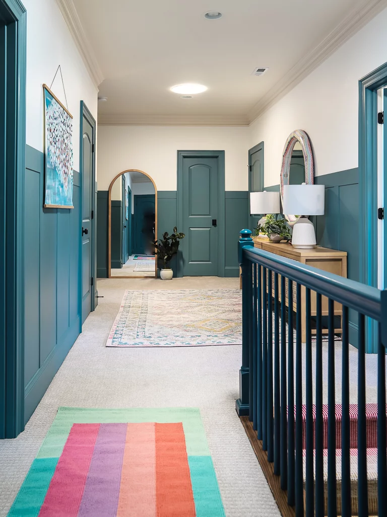 rug over carpet in colorful hallway