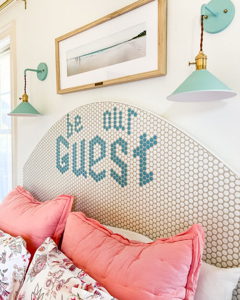 diy headboard with message that says "be our guest"