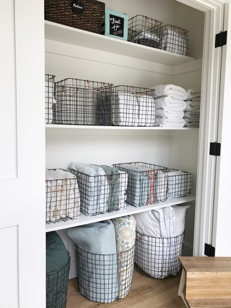 linen closet using vertical folding in wire baskets