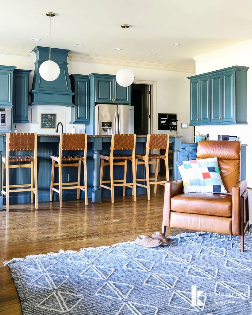 great room with blue cabinets and rug