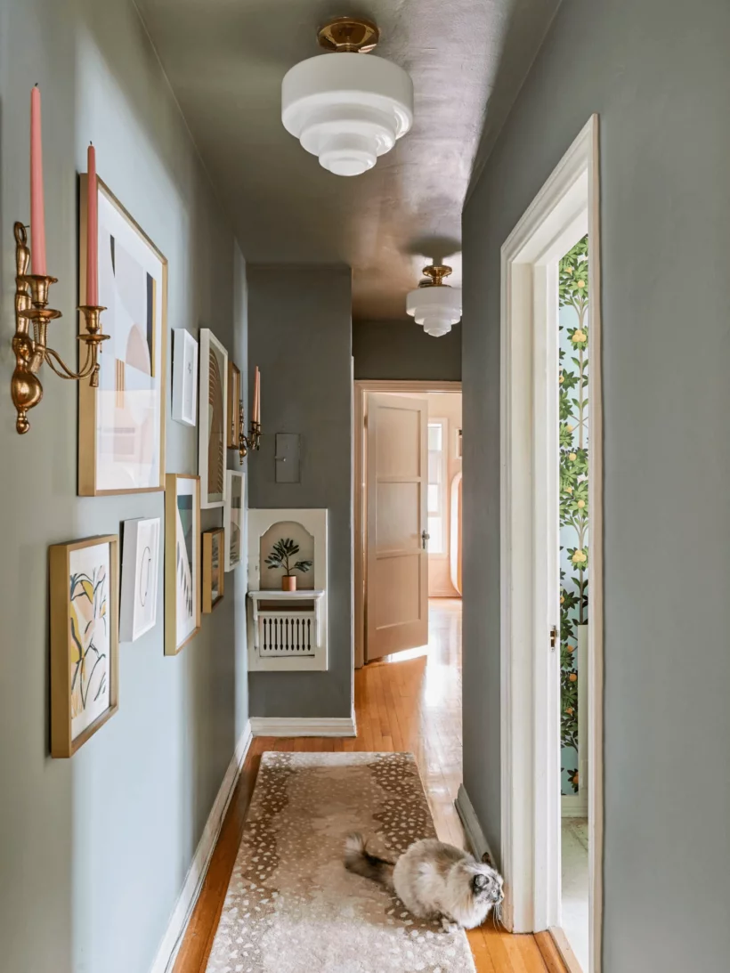 long hallway with gallery wall and matching light fixtures