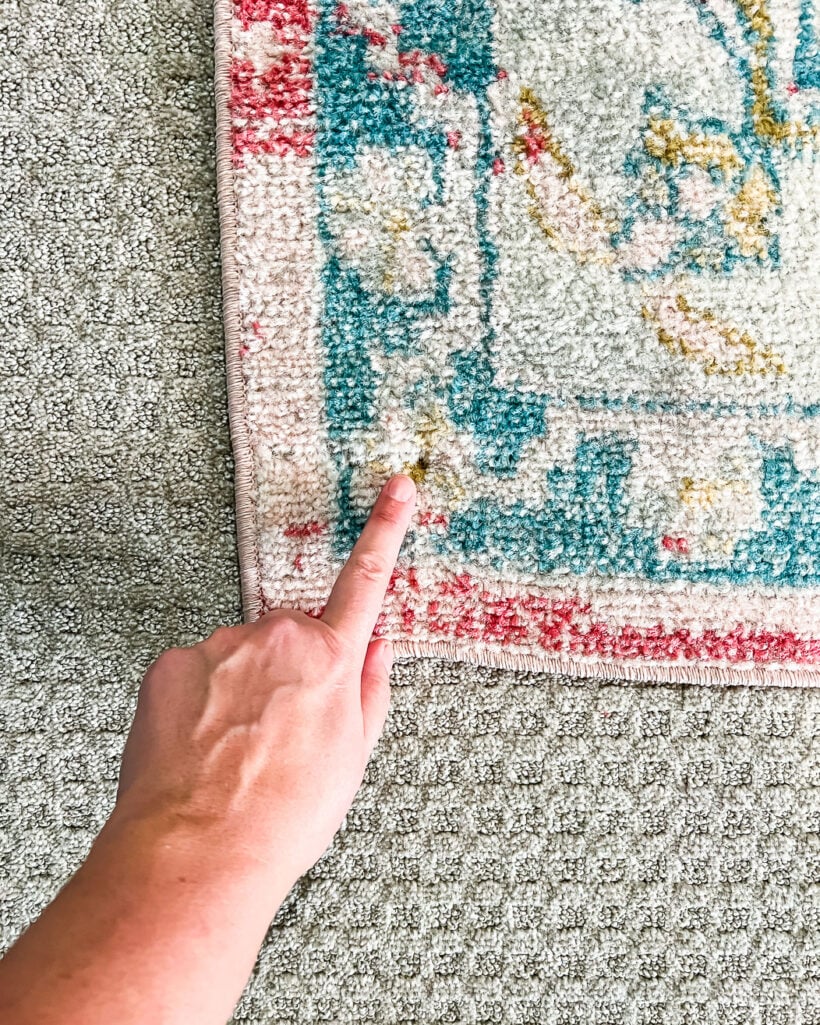 corner of rug screwed into carpet