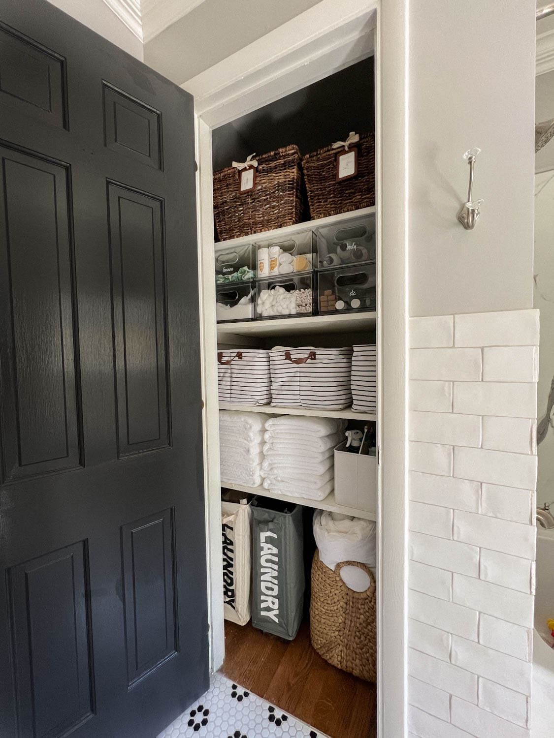 small bathroom linen closet that is neatly organized