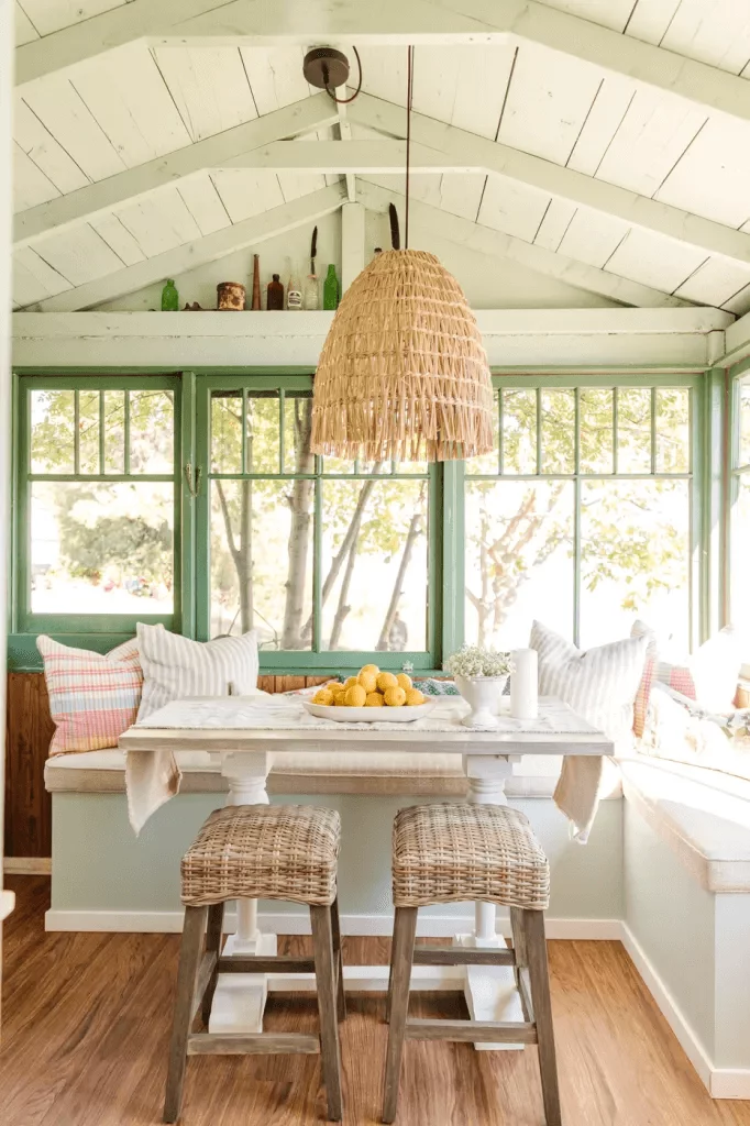 eating area with built in seats and green windows