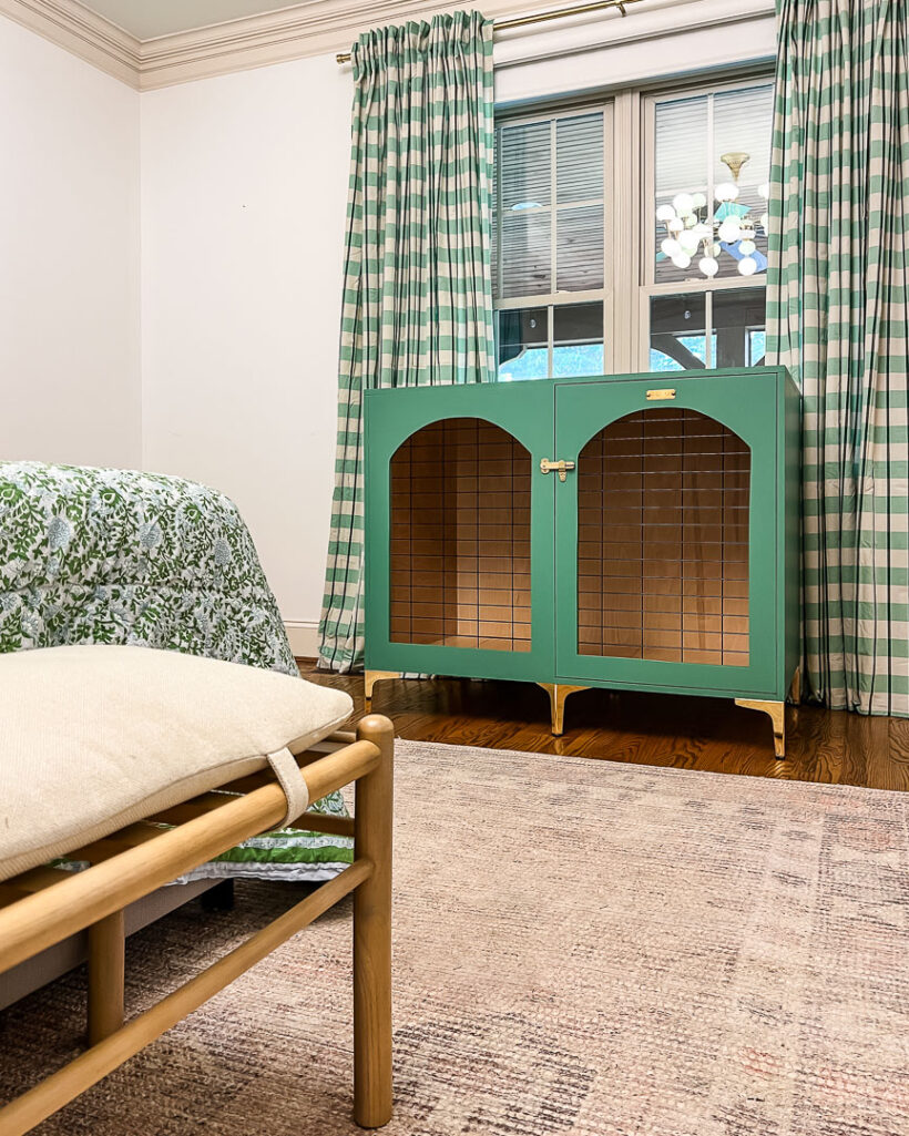 DIY wood dog crate that looks like furniture on display in green bedroom