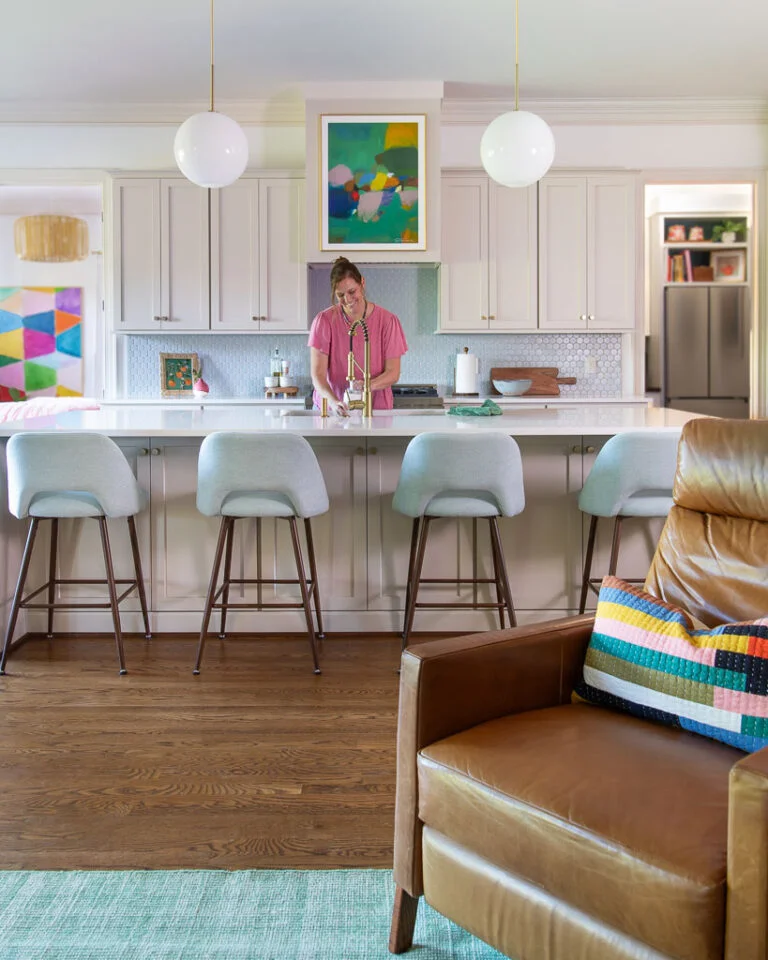 Tasha Agruso of Gadgetronicx washing dishes in newly renovated kitchen with kitchen cabinets painted Accessible Beige by Sherwin Williams